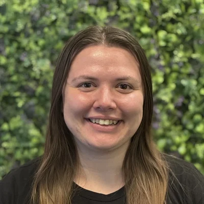 Megan Joseph smiling in front of greenery